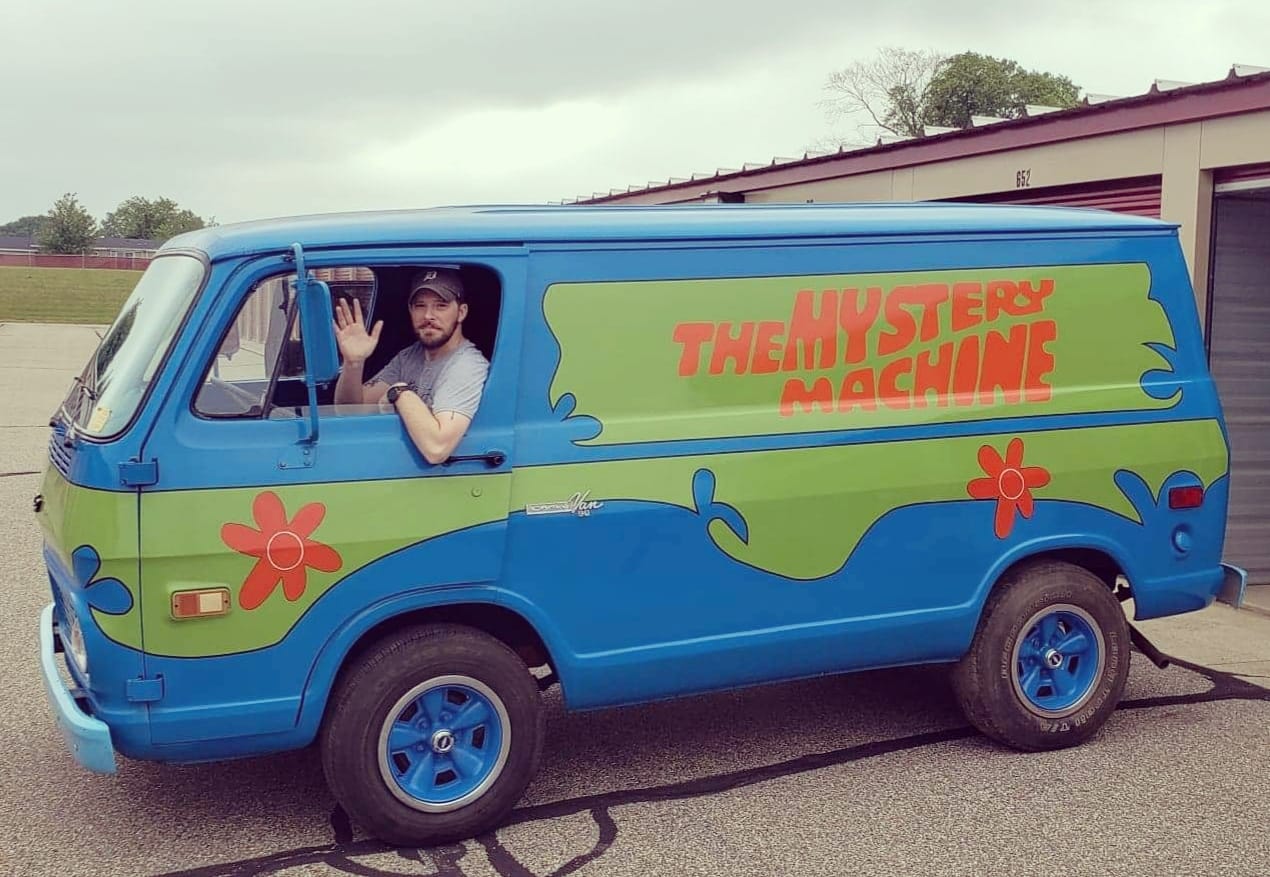 Curtis waving from the Mystery Machine